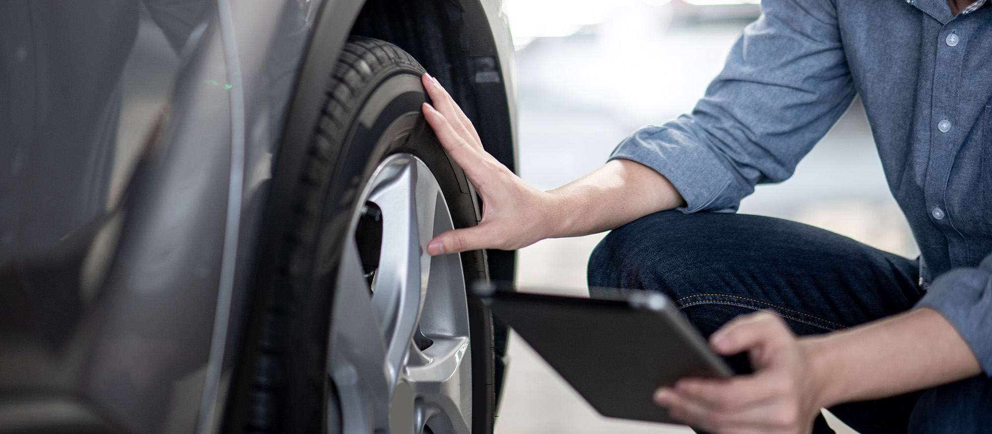 Technician inspecting tire condition and wear
