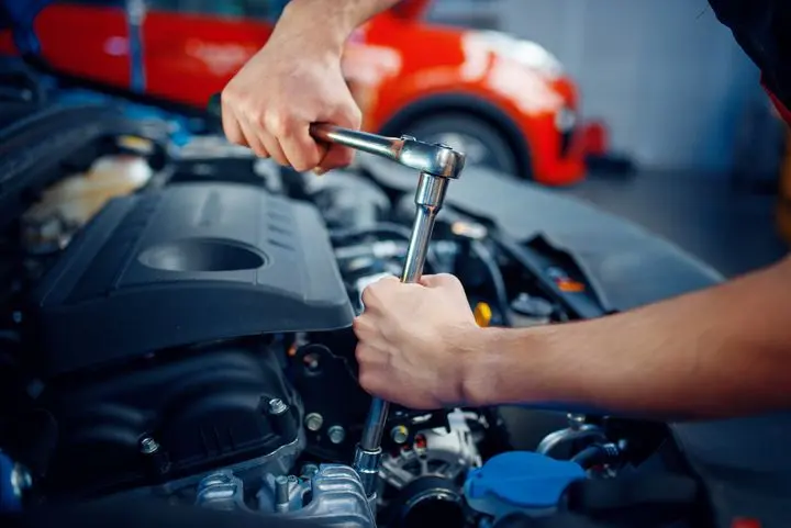 Routine vehicle maintenance being performed on a lift